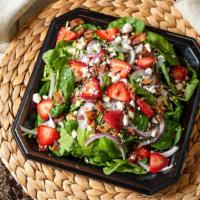 Strawberry Spinach Salad · Delicate baby spinach with diced bacon, sliced strawberries, Feta cheese, onion, and toasted...