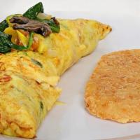 Garden Omelette · Stuffed with onion, bell pepper, mushroom, and spinach. Served with hash browns.