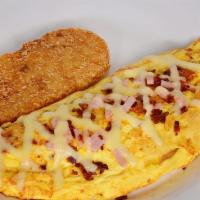 Meat Lovers Omelette · Stuffed with ham, sausage, bacon, and melted cheese. Served with hash browns.
