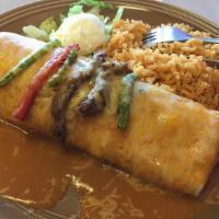 Steak Fajitas Burrito · Grilled steak, peppers and onions with beans and cheese inside, enchilada style.