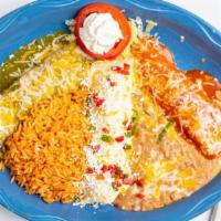 Mi Pueblo Enchilada · Chicken, beef and cheese enchiladas topped with our three different sauces.