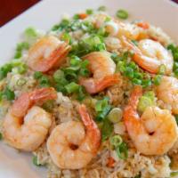 Fried Rice · Fried rice, egg, diced yellow onions, green onions, carrots, and peas.