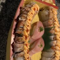 Happy Roll · Shrimp tempura, crab, cucumber, topped with shrimp, avocado and special sauce.