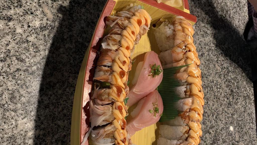 Happy Roll · Shrimp tempura, crab, cucumber, topped with shrimp, avocado and special sauce.