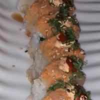 Crazy Roll · Spicy tuna, cucumber, gobo, topped with spicy yellow tail, siracha and green onions.
