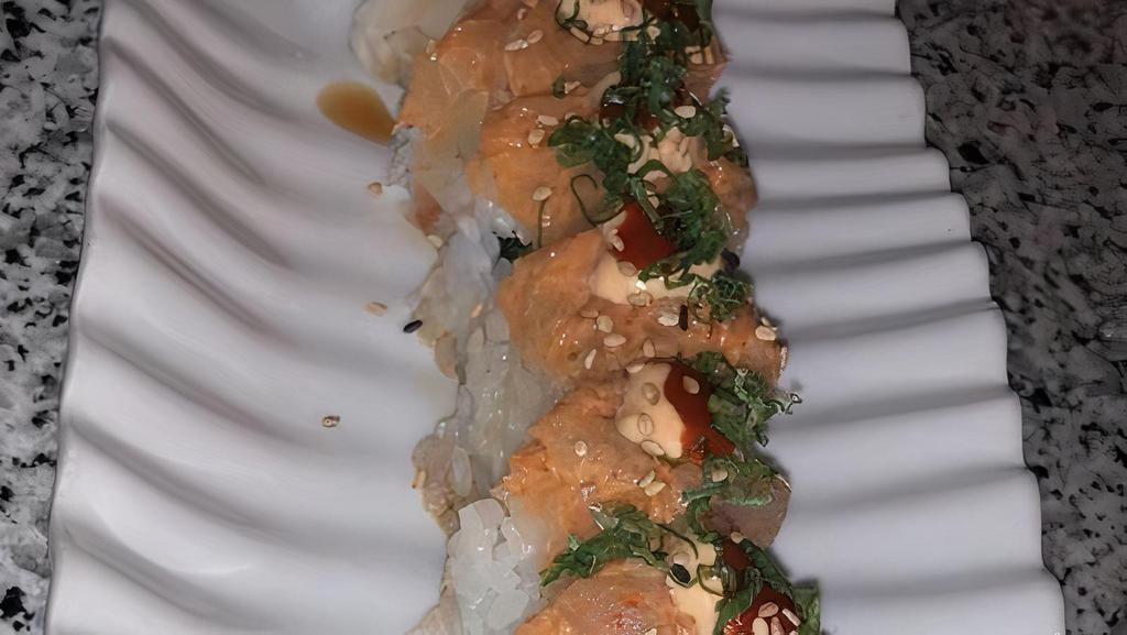 Crazy Roll · Spicy tuna, cucumber, gobo, topped with spicy yellow tail, siracha and green onions.