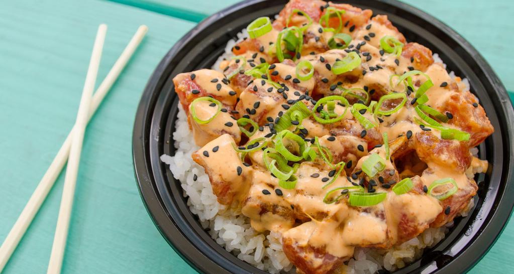 Spicy Tuna Poke Bowl · Gluten free. Dairy free. Marinated sashimi grade ahi tuna cubes tossed in creamy spicy-mayo with masago. Garnished with scallions. Served over freshly steamed rice.