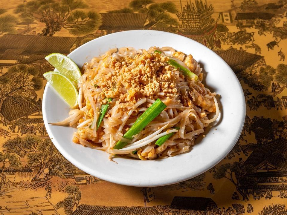 Pad Thai · Fresh rice noodles sauteed with chicken or tofu, egg, scallions, bean sprouts, and ground peanuts, served with a side of lime.
