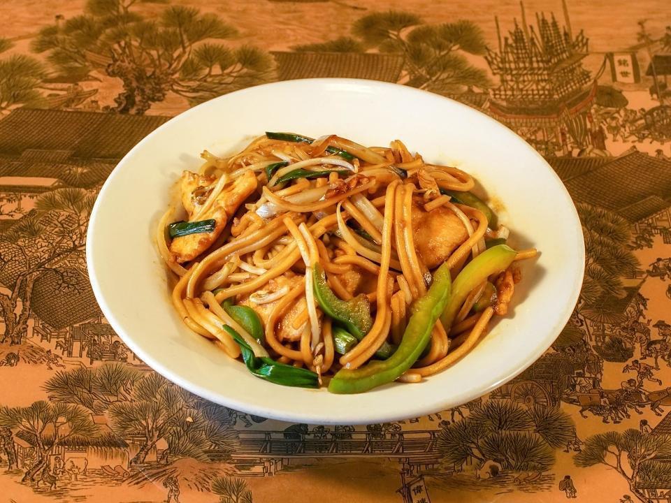 Lo Mein · Wheat noodles stir-fried with yellow onions, scallions, bell peppers, and bean sprouts in a ginger soy sauce.