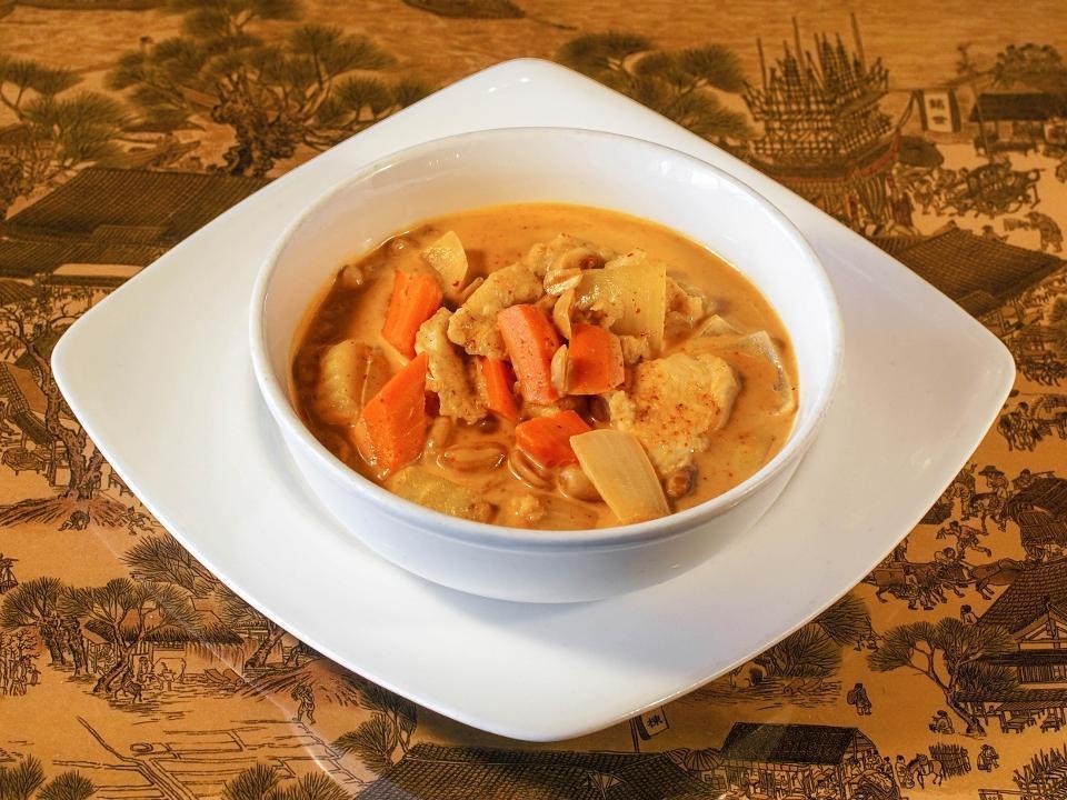 Massaman Curry · Potatoes, carrots, onions, and peanuts simmered with coconut milk in dried red chili, tamarind juice, lemongrass, galangal root curry paste.