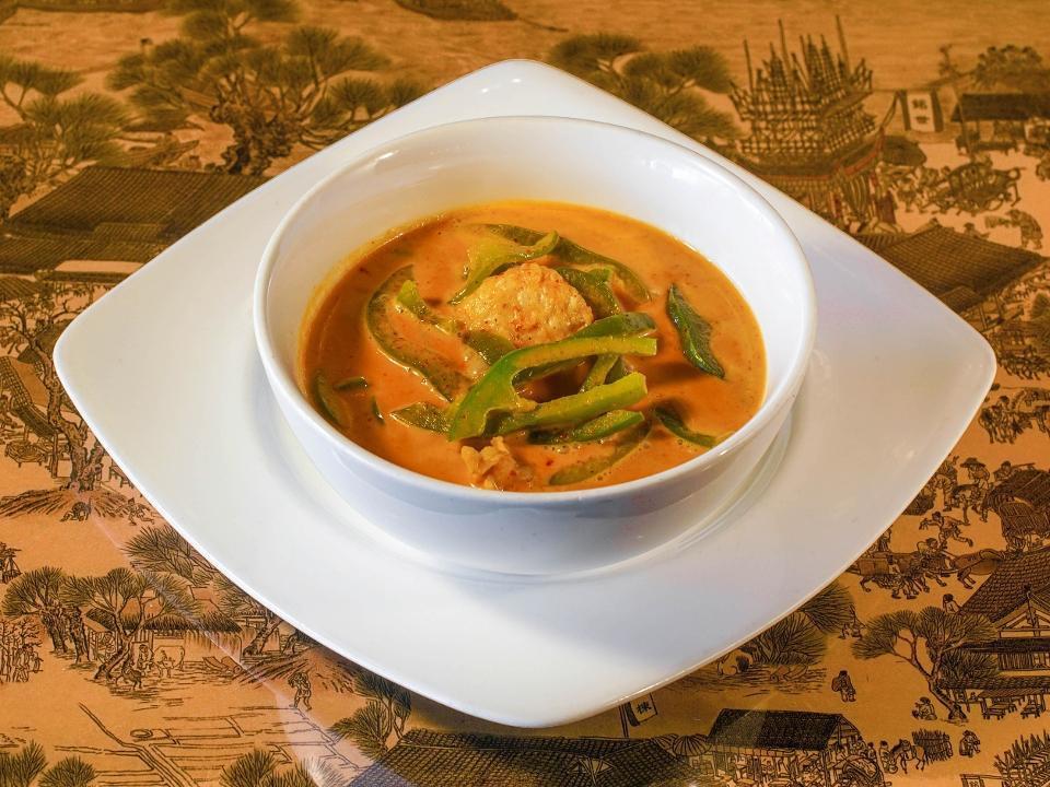Panang Curry · Bell peppers and kaffir lime leaves simmered with coconut milk, dried red chili, lemongrass, and galangal root curry paste.