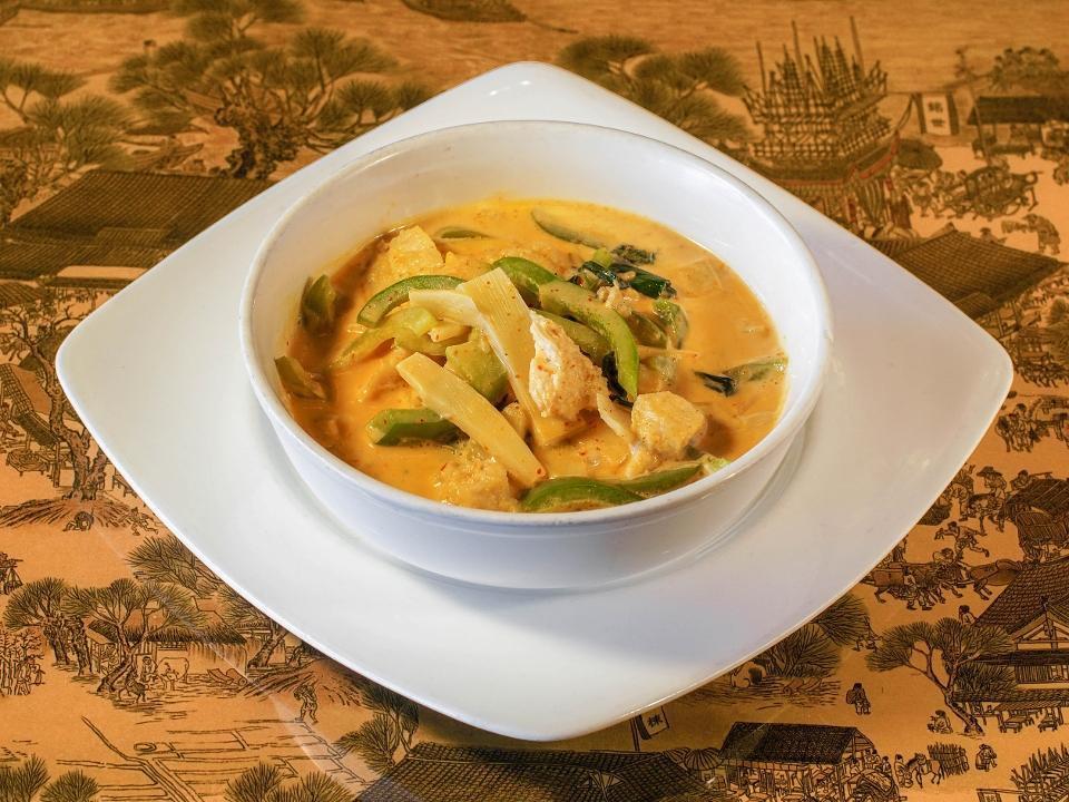 Red Curry · Bamboo, bell peppers, and Thai basil simmered with coconut milk in dried red chili, lemongrass, and a galangal root curry paste.