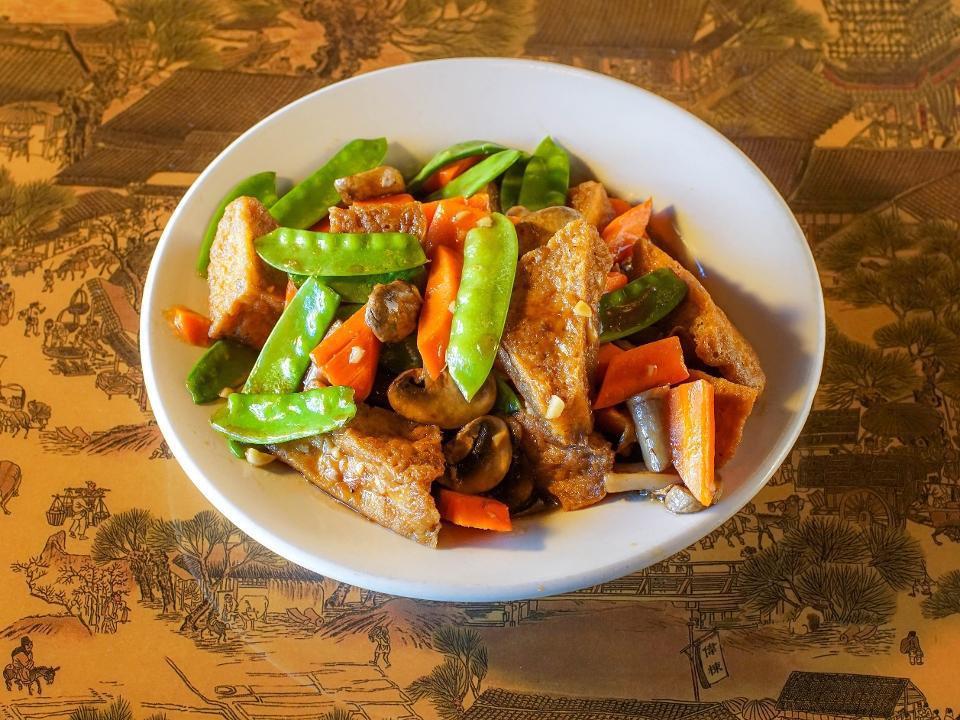 Hot Braised Tofu · Braised Tofu wok tossed with carrots, bok choy and mushrooms in a soy reduction.