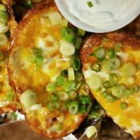 Potato Skins · Topped with bacon, mozzarella and cheddar cheese. Topped with chives and served with sour cr...