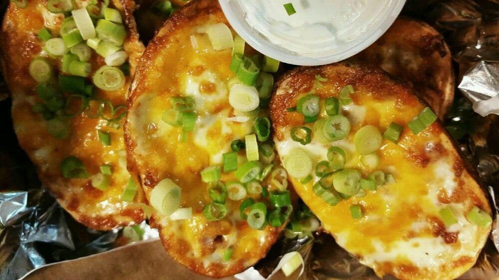 Potato Skins · Topped with bacon, mozzarella and cheddar cheese. Topped with chives and served with sour cream.