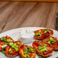 Potato Skins · Cheddar jack cheese, bacon, green onions, and sour cream.