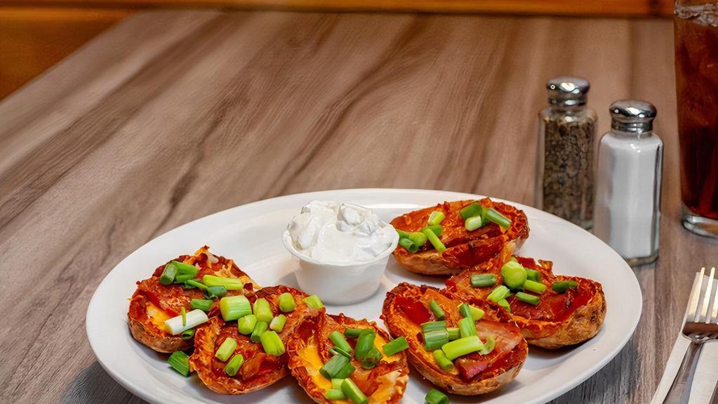 Potato Skins · Cheddar jack cheese, bacon, green onions, and sour cream.