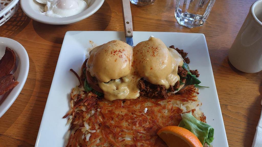 Benedict With Chorizo · Atop an open-faced English muffin with two poached eggs & topped with Hollandaise sauce served with hash browns or fresh fruit.