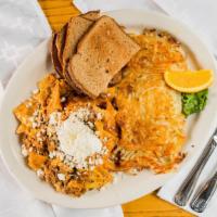 Migas · Three eggs scrambled with chorizo, tortilla chips & salsa - topped with green onions, sour c...