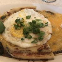 Huevos Rancheros · Black beans, ranchero sauce, sour cream, green onions & Tillamook cheddar cheese on top of t...