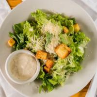 Caesar Salad · Romaine, croutons & parmesan - tossed with caesar dressing & served with garlic bread.