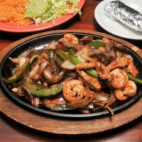 Steak & Shrimp Fajitas · Delicious marinated shrimp and delicious steak sautéed with bell peppers and onions, served ...