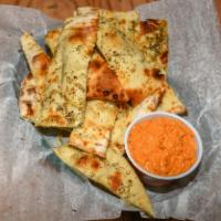 Hummus Flatbread · Our roasted red pepper hummus served with fresh-made, oven flatbread that is sprinkled with ...