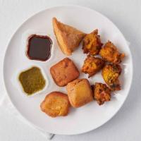 Vegetarian Combo Platter · Assortment of vegetables and paneer pakoras and a samosa, served with chutneys.