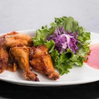 Chicken Wings · Deep-fried marinated chicken wings, served with a sweet and sour dipping sauce.