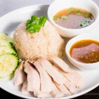 Kao Mun Gai · Steamed chicken served over ginger jasmine rice with a side of chicken broth and homemade fe...
