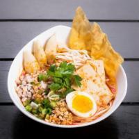 Tom Yum Noodle · Egg noodles, ground pork, steamed fish cakes, fish balls, bean sprouts, and ground peanuts i...