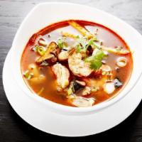 Tom Yum Soup · An individual size of spicy-sour soup with straw mushroom caps, lemongrass and galangal root.