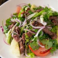 Beef Salad · Tender slices of grilled New York steak tossed in cucumbers, tomatoes, red onions, green oni...