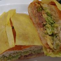 Machaca Torta · Shredded Beef (Cooked with onions, tomato, bell pepper and egg). With guacamole and lettuce.