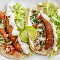 Fish Taco Plate · Two deep fried fish tacos with lettuce, pico de gallo and tartar sauce.
 Sides: Rice and bea...