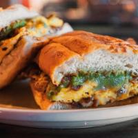 Breakfast Torta Sandwich · This massive breakfast sandwich is made with fresh baked bread, 4 scrambled eggs, cheese, pi...