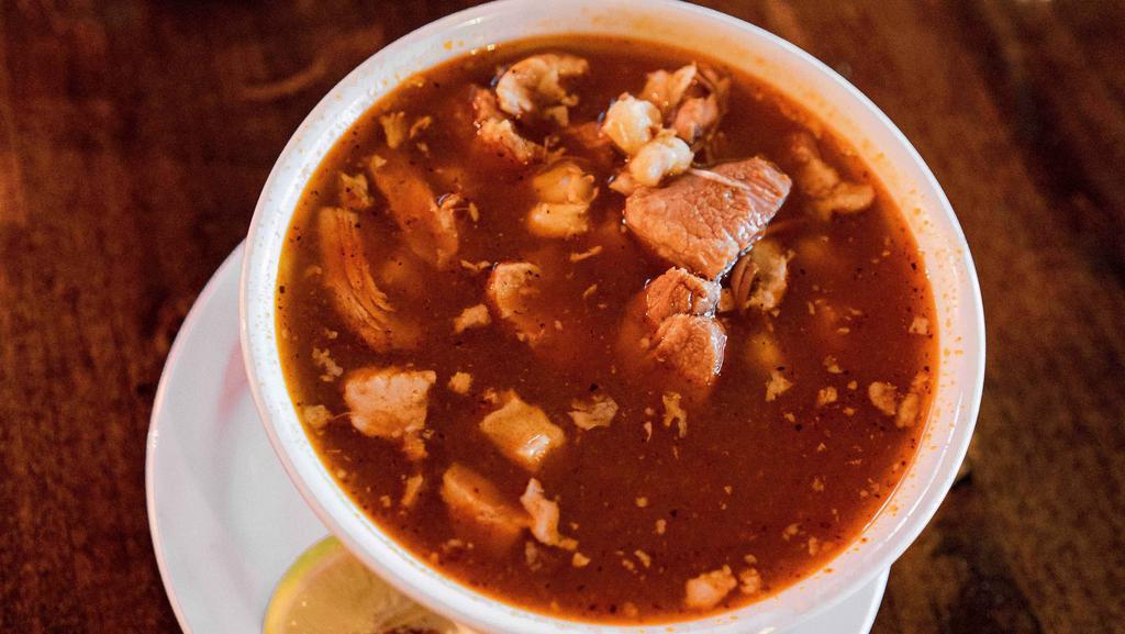 Pozole  (24Oz) · A hearty and savory pork broth cooked with chunks of pork, white corn hominy and spices. Served with side toppings of white cabbage, onion, oregano, chili flakes, and a lime wedge.