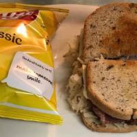 Reuben Sandwich · Your choice of thinly sliced corn beef or turkey on toasted rye bread with sauerkraut, Swiss...
