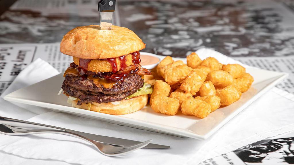 Pac-12 Burger · Bacon, cheddar cheese, BBQ sauce & topped with onion ring, served with your choice of fry
