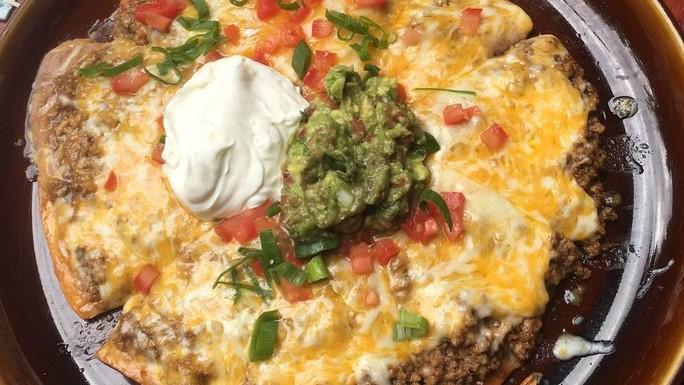 Mexican Pizza · Crispy flour tortilla with meat, refried beans, and cheese garnished with tomatoes, onions, guacamole, and sour cream. Add shrimp for an additional charge.