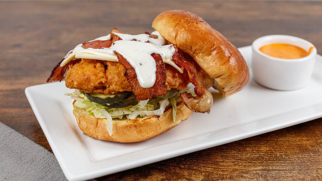 Fun Time Sally Sandwich · Crispy fried chicken breast topped with American cheese, bacon, ranch dressing, lettuce, and dill pickles on buttery grilled brioche roll.