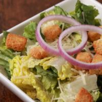 Side Caesar Salad · Romaine, croutons, parmesan, and red onion.  Served with Caesar dressing.