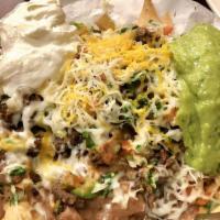 Super Nachos · Served with beans guacamole pico cheese sour cream and choice of meat