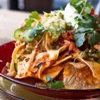 Nachos Piled High · Cheese, guacamole, sour cream, chicken tinga or beef for an additional charge.