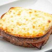 Croque Monsieur Chéri · The traditional french hot sandwich made with ham, cheese, dijon mustard, gratiné with flavo...