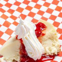 Cheesecake · Creamy cheesecake served with strawberries and whipped topping.