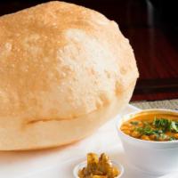 Chana Bhatura · Chana masala (garbanzo curry), garnished with onions. Served with large Indian fry breads an...