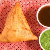 Samosa (1 Pc) · Crispy pastries stuffed with deliciously spiced potatoes and peas, served with mint-coriande...