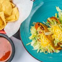 Hard Shell Tacos · Crispy corn tortilla filled with your choice of meat, lettuce, cheese, and tomatoes.