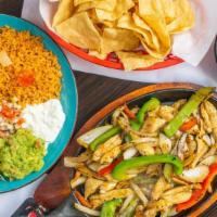 Fajitas · Choice of meat sautéed with onions and bell peppers and our special marinade, guacamole and ...